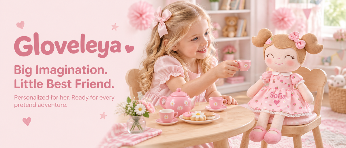 A girl enjoying a pretend tea party with a Gloveleya strawberry doll personalized with Sofia and a heart.